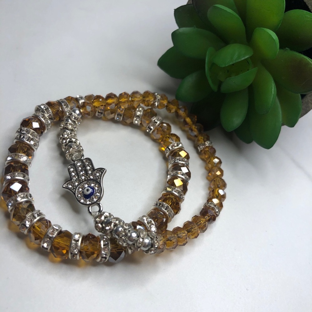 Set of 2 jeweled bracelet one has a Hamsa Charm.